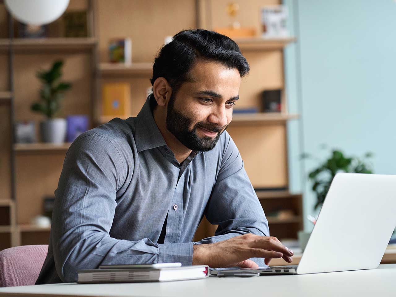 man at home studying on laptop