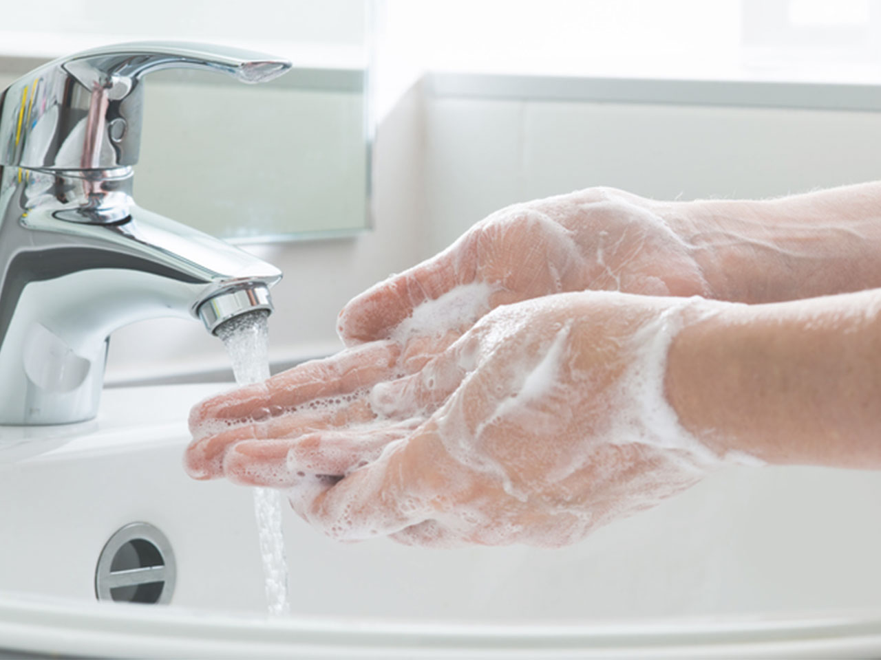 washing hands with soap under running water'