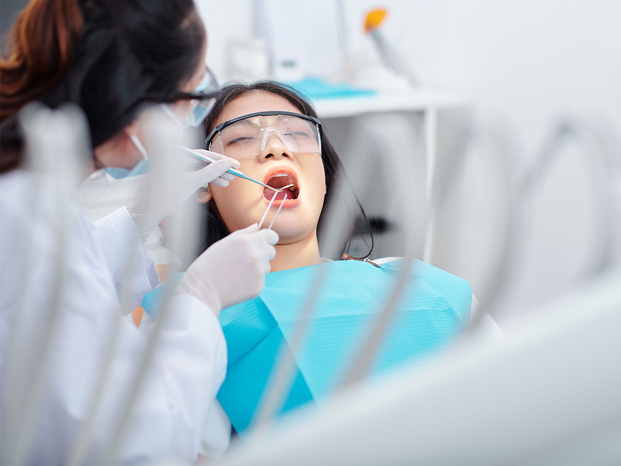 dental professional working on patient wearing PPE