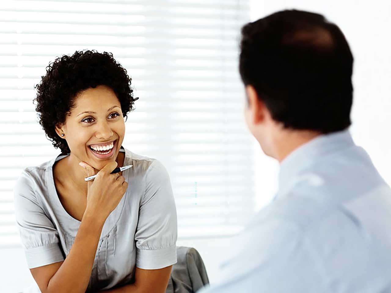 woman smiling at man in business setting