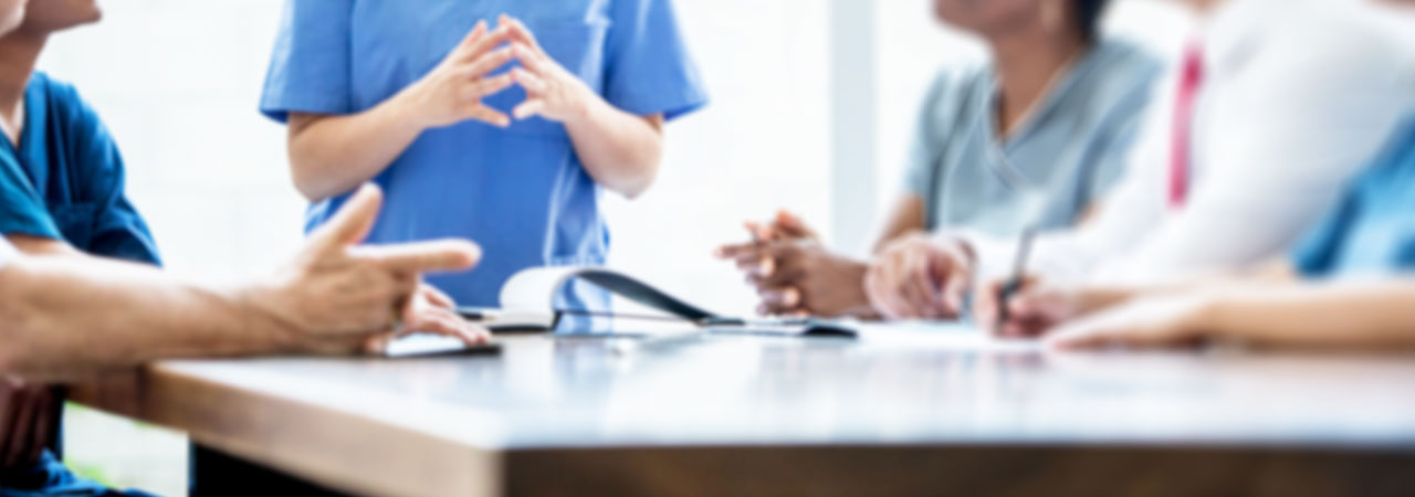 View of table where dental industry professionals are in discussion