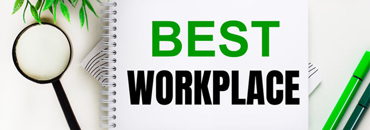 notebook with "best workplace" message on desktop