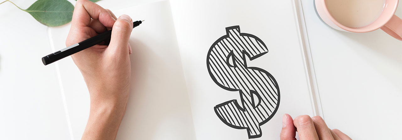 hand drawing a dollar sign in a notebook