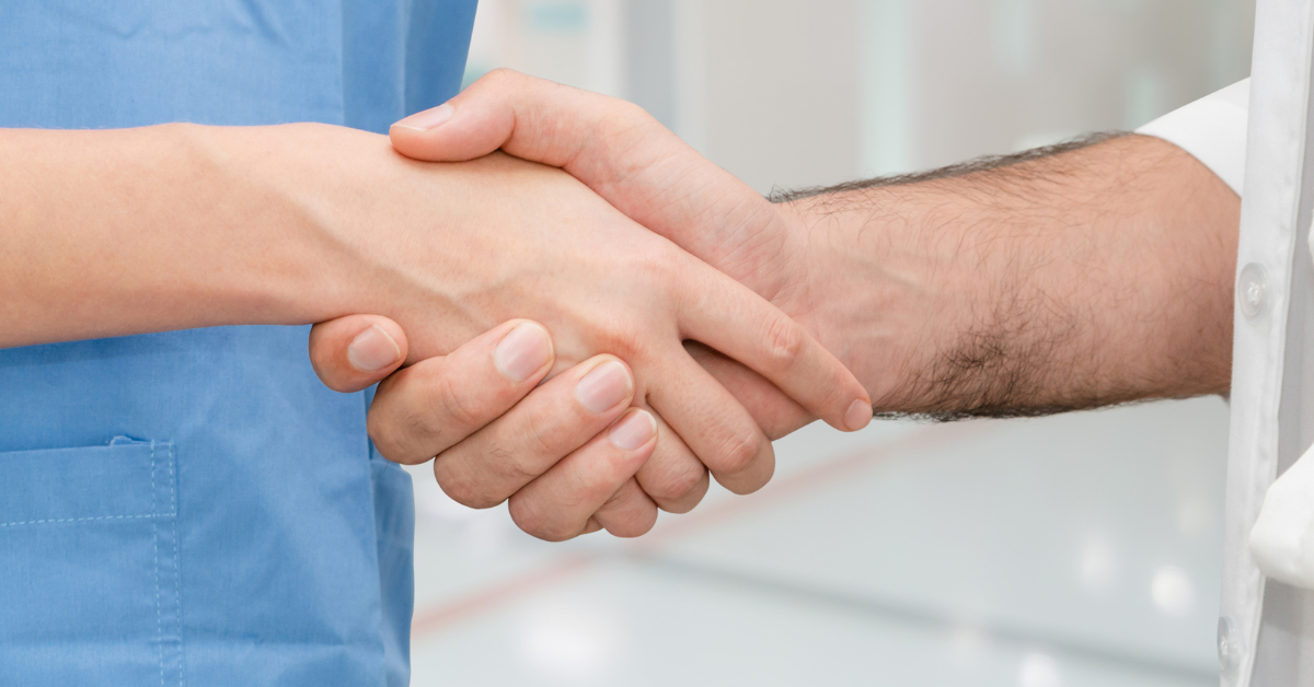 nurse and doctor shake hands
