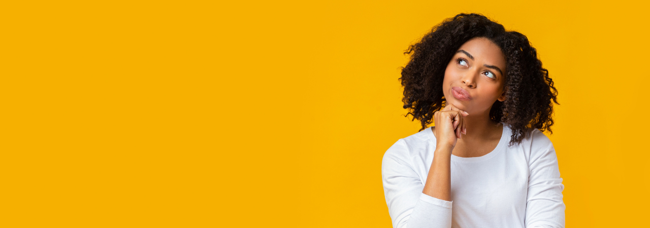 Person thinking with their chin rested on their hand in front of a yellow background
