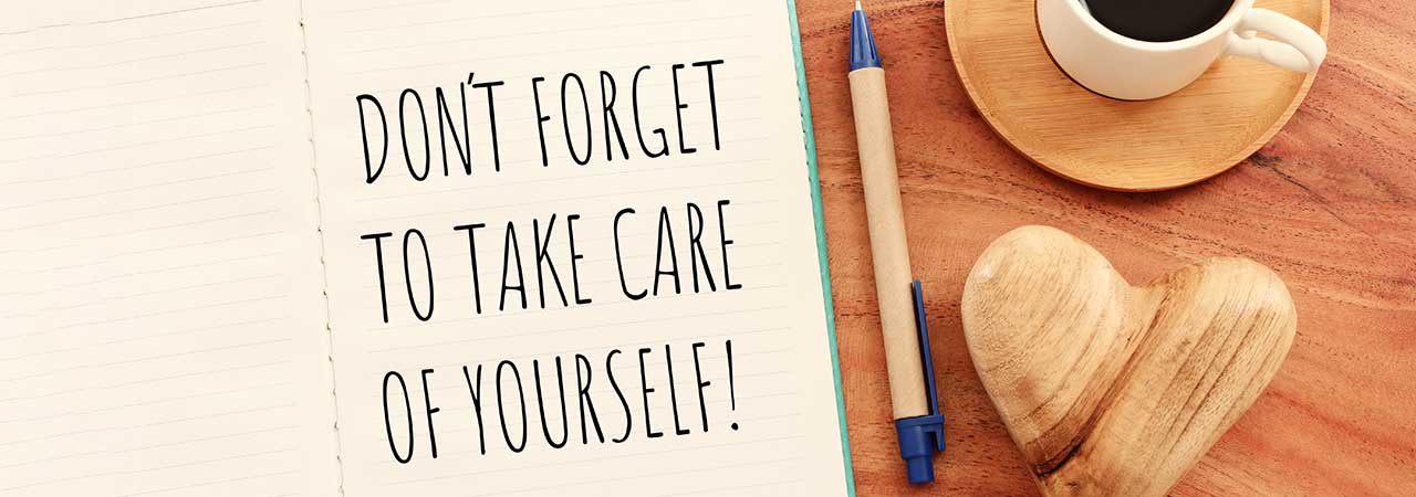 pen and notebook with a message that says "Don't forget to take care of yourself"