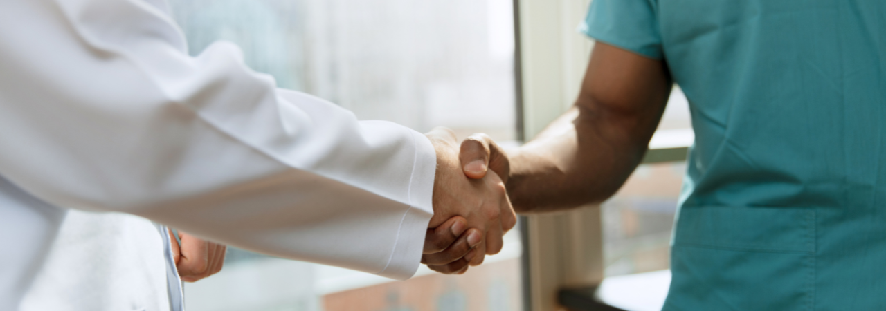 dentist and dental assistant shaking hands