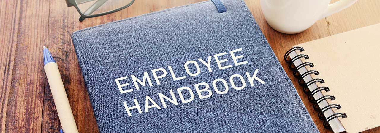 an employee handbook sitting on a table