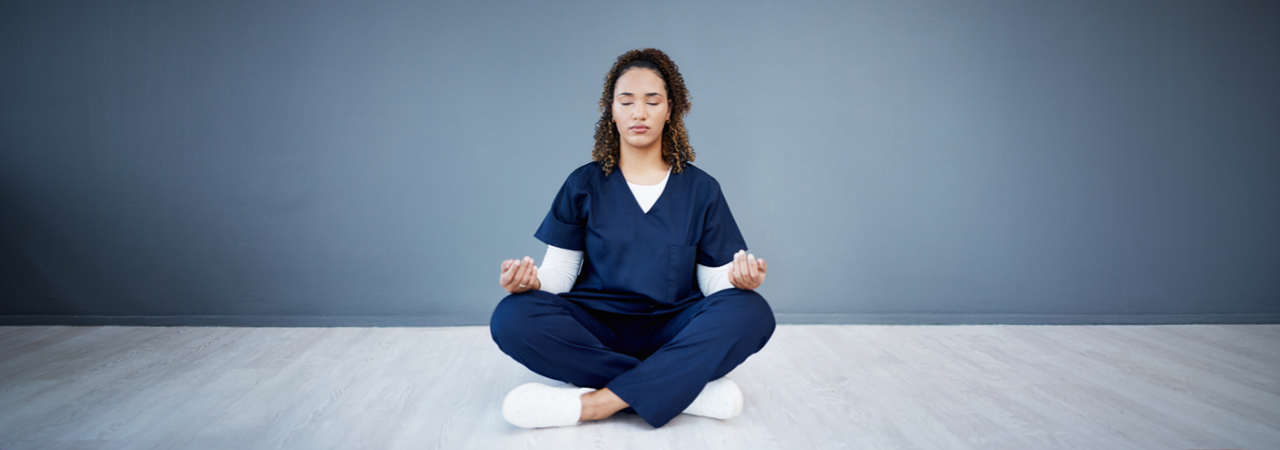 dental assistant woman in scrubs sitting in meditation