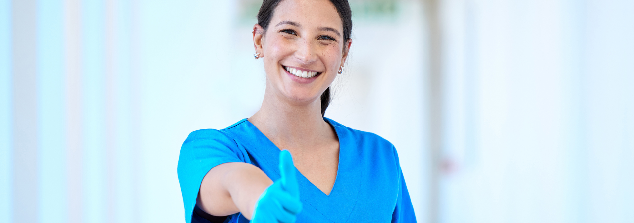 dental assisting smiling and giving a thumbs up