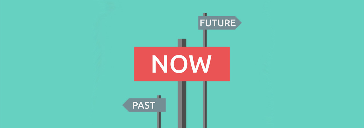three signs; one pointing to the left that says "past," one in the center that says "now," and one pointing right that says "future"