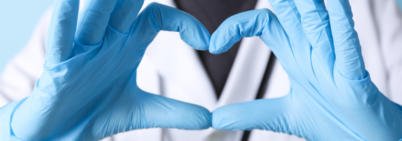 close-up of a medical professional making a heart shape with their hands