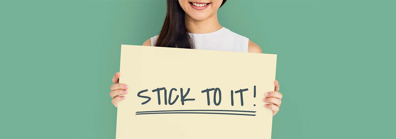 woman holding encouragement sign