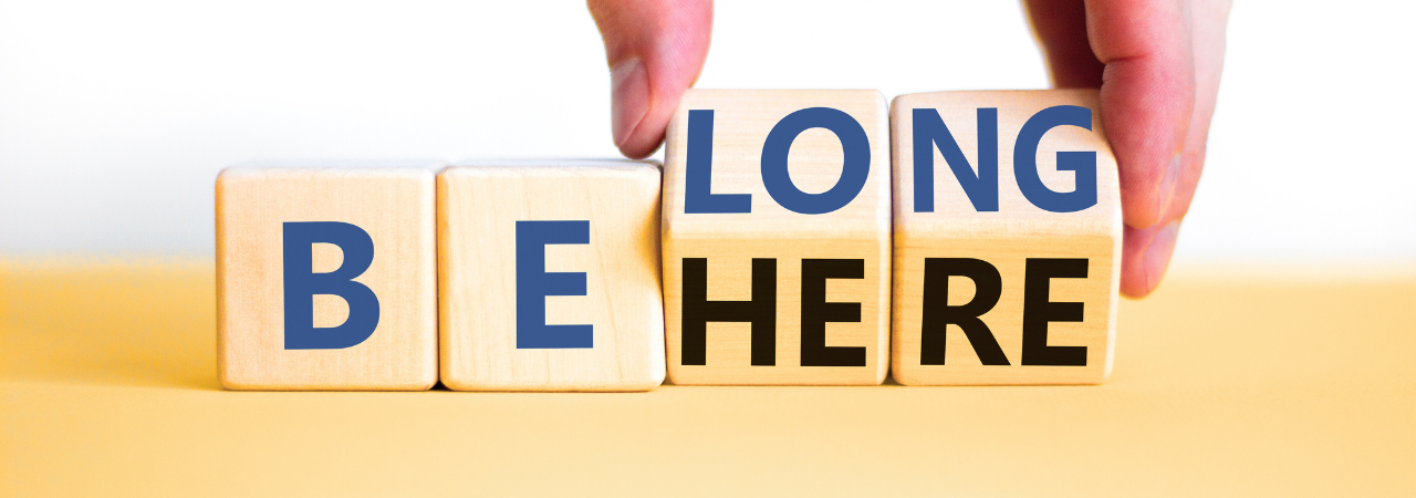 Wooden blocks with the phrase "Belong Here"