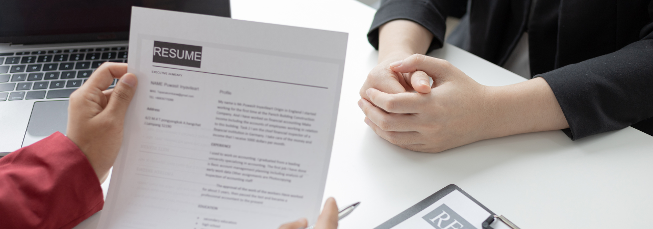 Job interviewer reviewing a candidate's resume