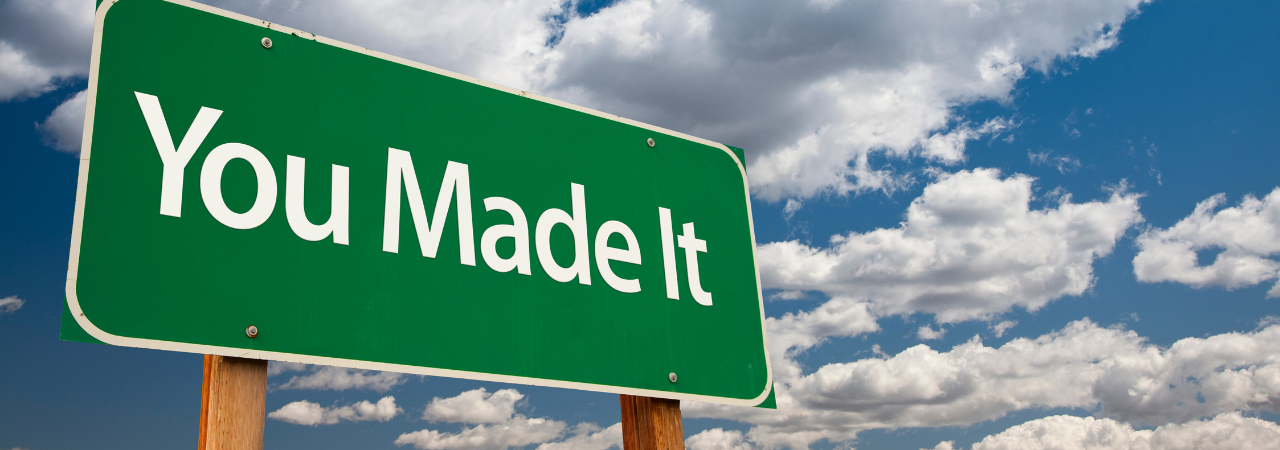 Green road sign with the text "You Made It"