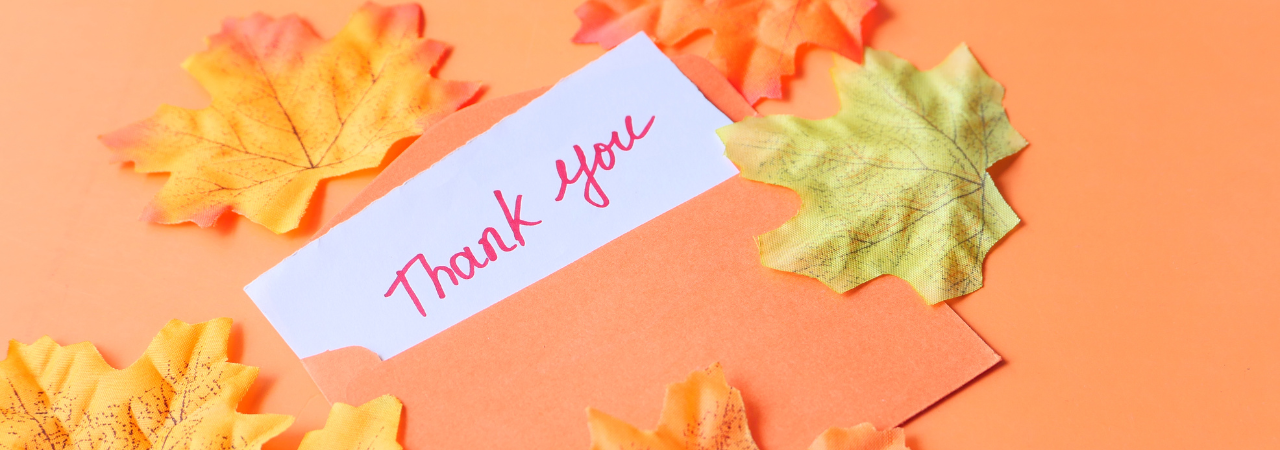Thank you note with fall leaves around it