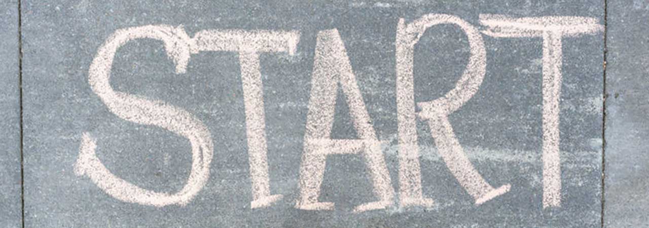 Word start spelled in chalk on sidewalk