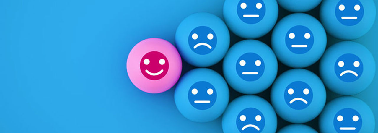 blue and pink spheres with emoticons showing neutral smiling and sad faces