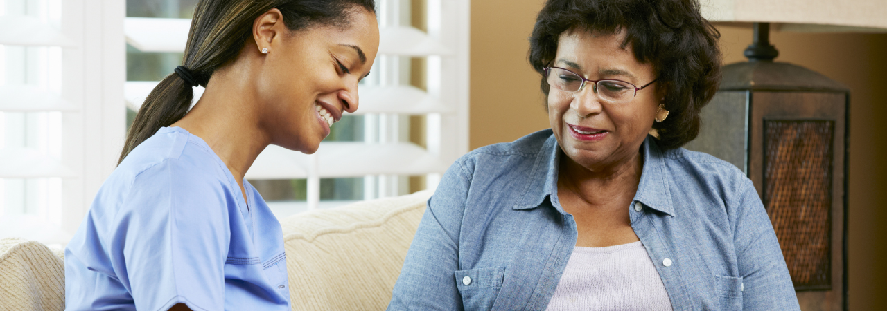 dental assistant talking to patient and writing notes