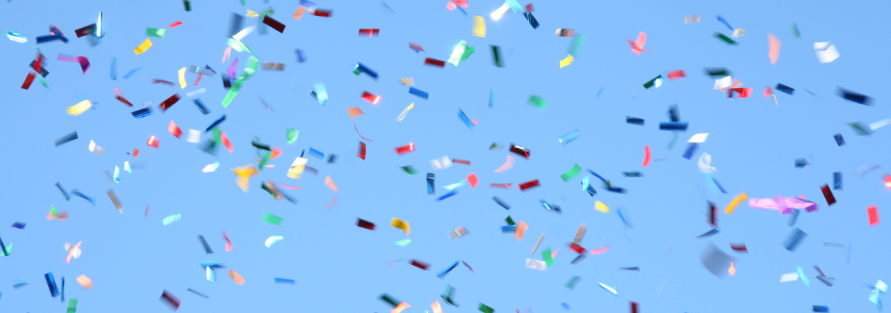 confetti falling in front of a blue background