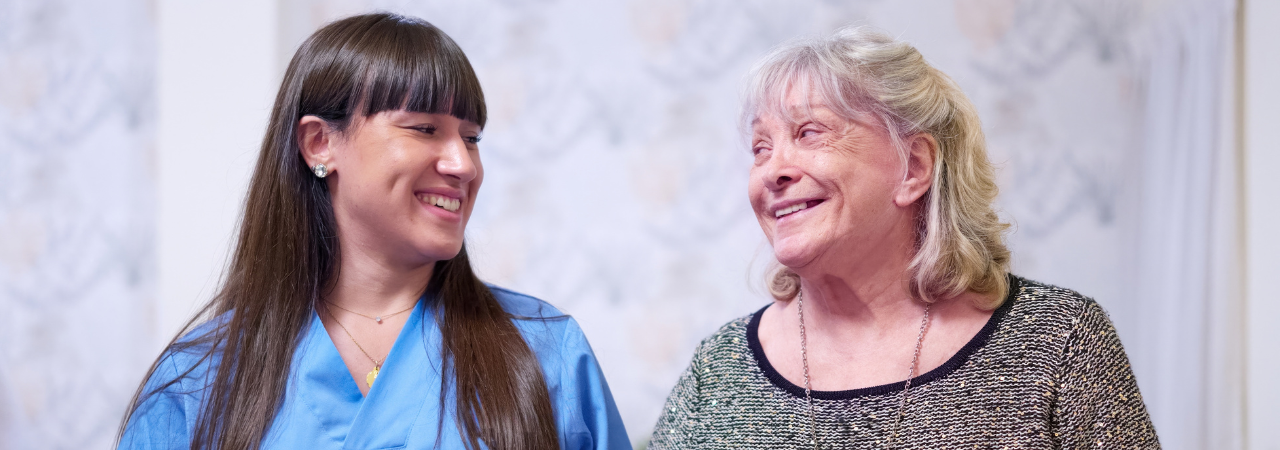 dental assistant and patient smiling at each other