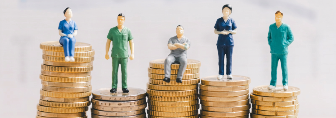 five stacks of coins with dental professionals sitting or standing on them
