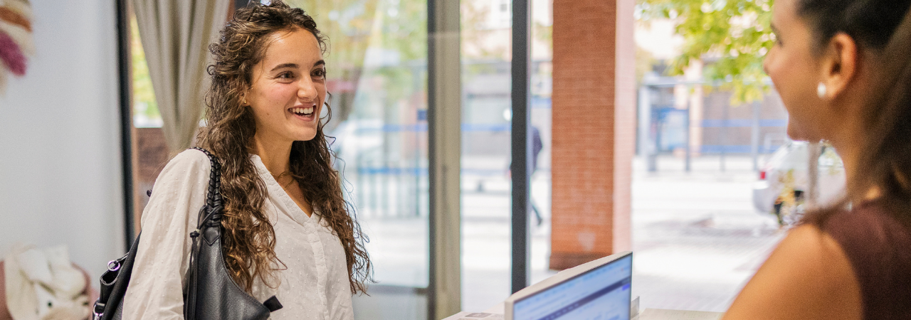 woman checking in at front desk