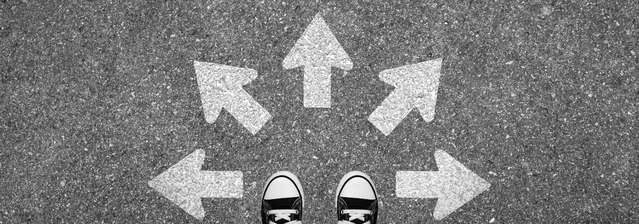 perspective of a person looking down at their feet, with arrows pointing several directions