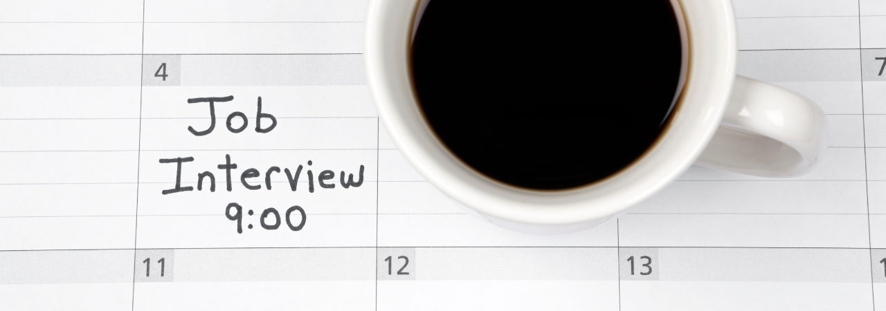 coffee cup on top of a calendar with the words "job interview 9:00"