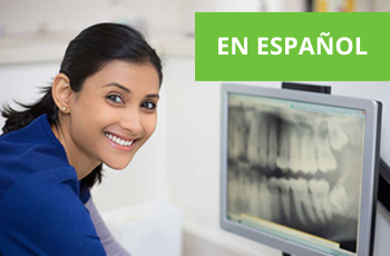 Dental assistant with digital x ray and text en espanol