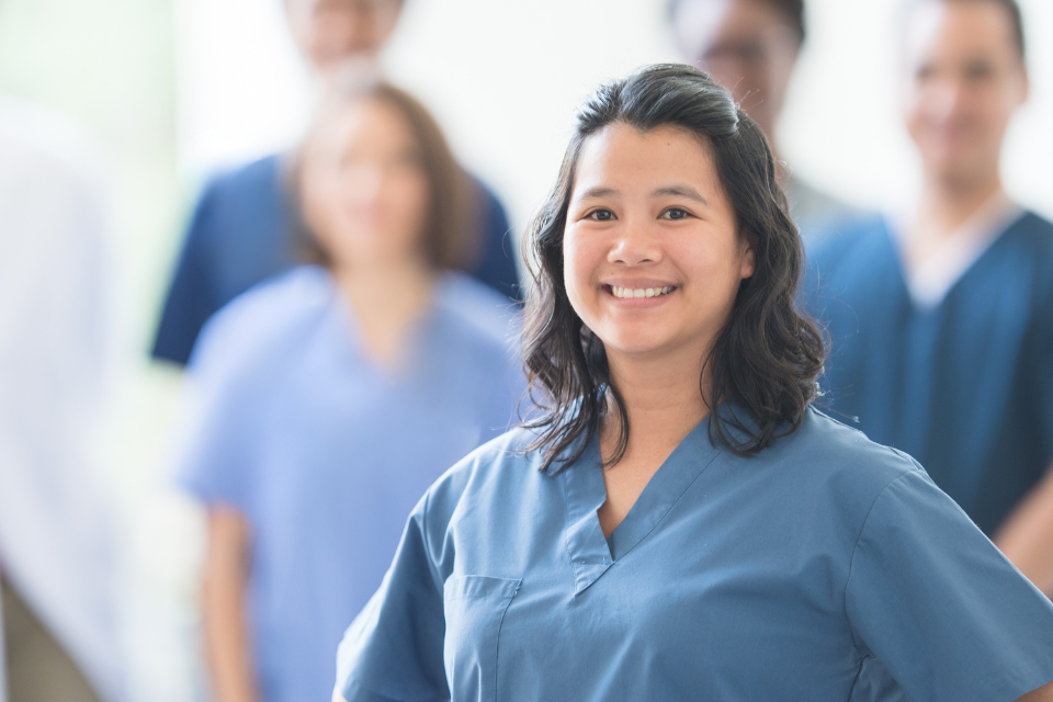 Dental assistant standing out from team