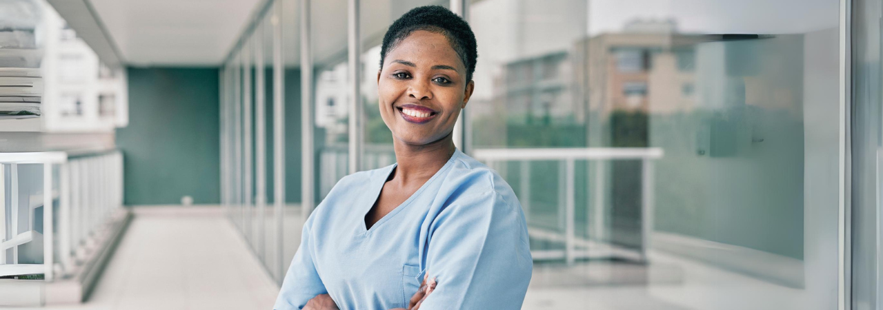 smiling dental assistant with crossed arms