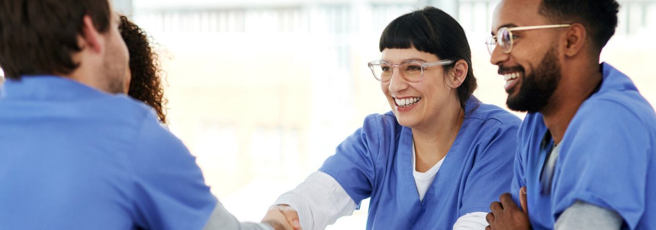 Dental assistants shaking hands at interview