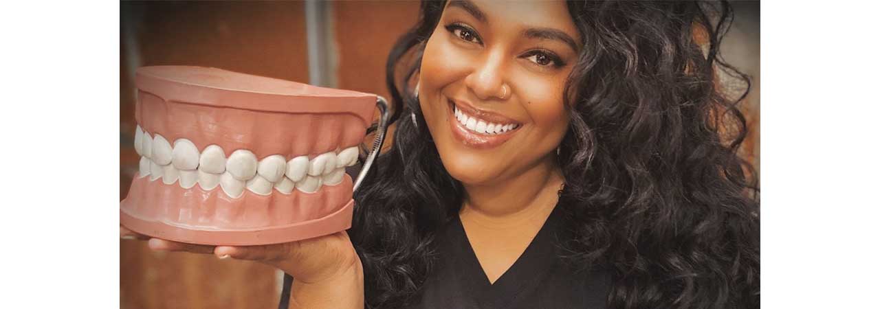 Marlyce Godoy holding model of teeth