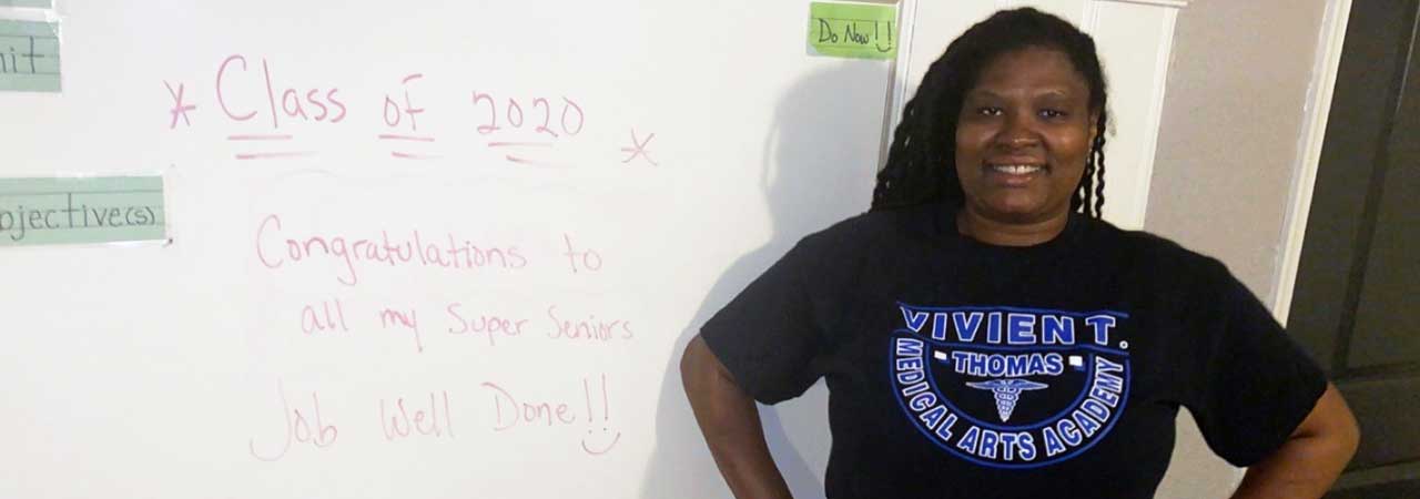 Dental assisting educator Yinka Bryant in front of white board