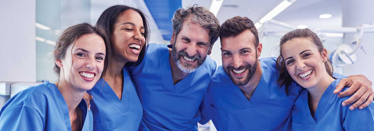 Group of happy dental assistants and dentists