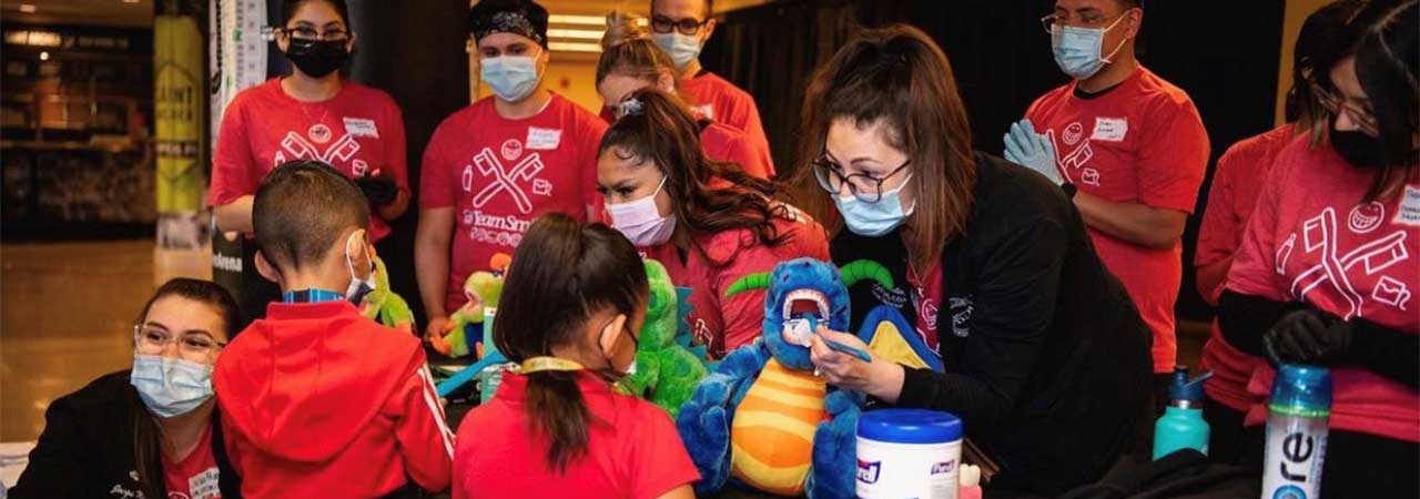 Whittney Greenleaf and dental assisting students volunteering at a Team Smiles event