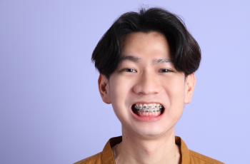 Smiling young man with braces